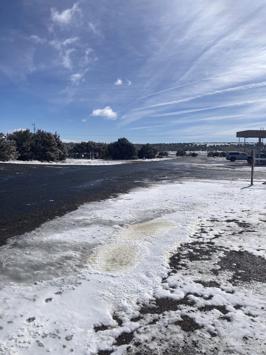 Snow along the road by a Concho gas station
